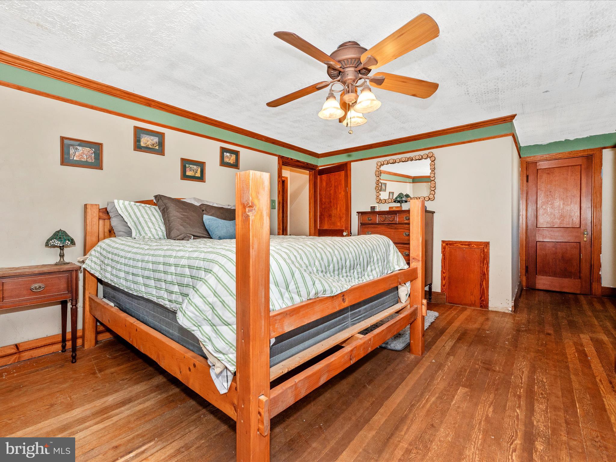 6103 Jefferson Pike Frederick, MD 21703 - Photo 33 of 57 a bedroom with a bed and a chandelier