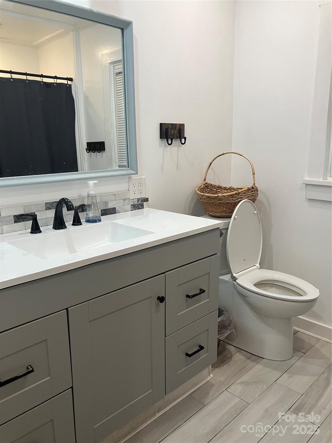 36704 Mauldin Road Albemarle, NC 28001 - Photo 17 of 33 a bathroom with a toilet sink and mirror