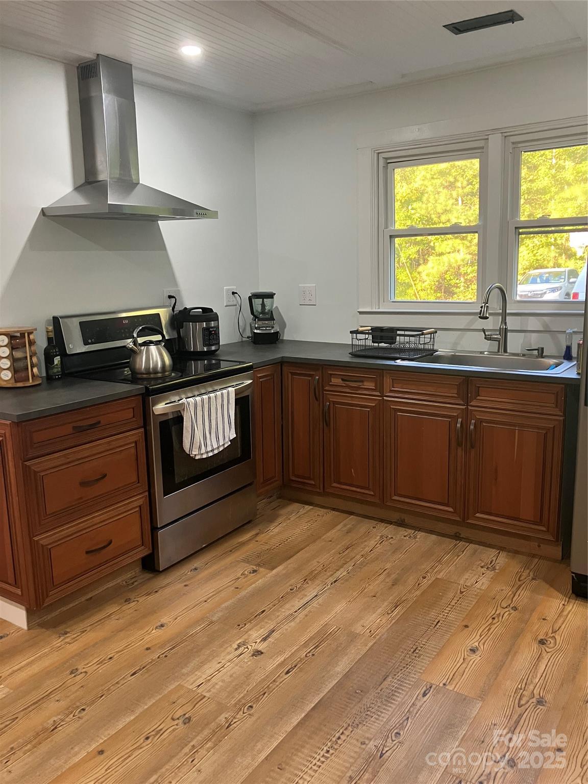 36704 Mauldin Road Albemarle, NC 28001 - Photo 20 of 33 a kitchen with stainless steel appliances granite countertop a stove a sink and a microwave