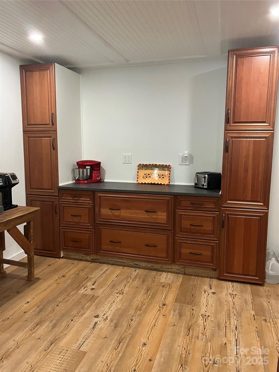 36704 Mauldin Road Albemarle, NC 28001 - Photo 22 of 33 a kitchen with granite countertop a refrigerator and wooden cabinets