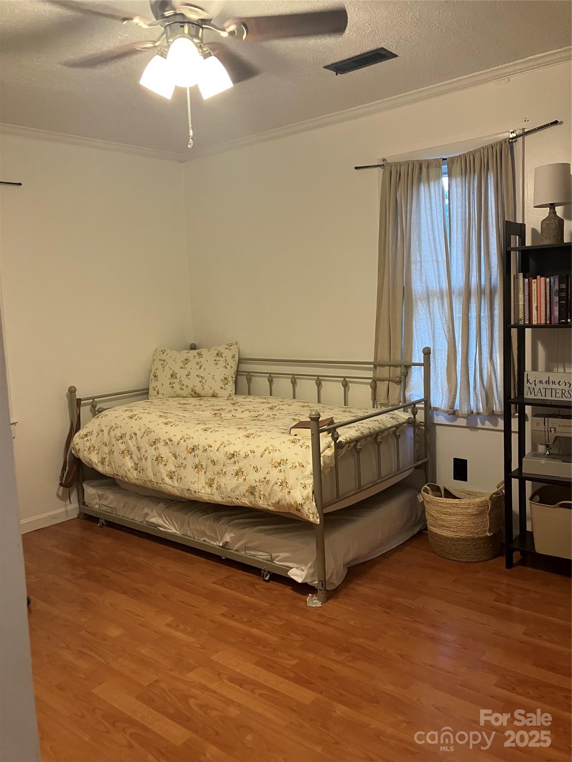 36704 Mauldin Road Albemarle, NC 28001 - Photo 32 of 33 a bedroom with a bed and a chandelier