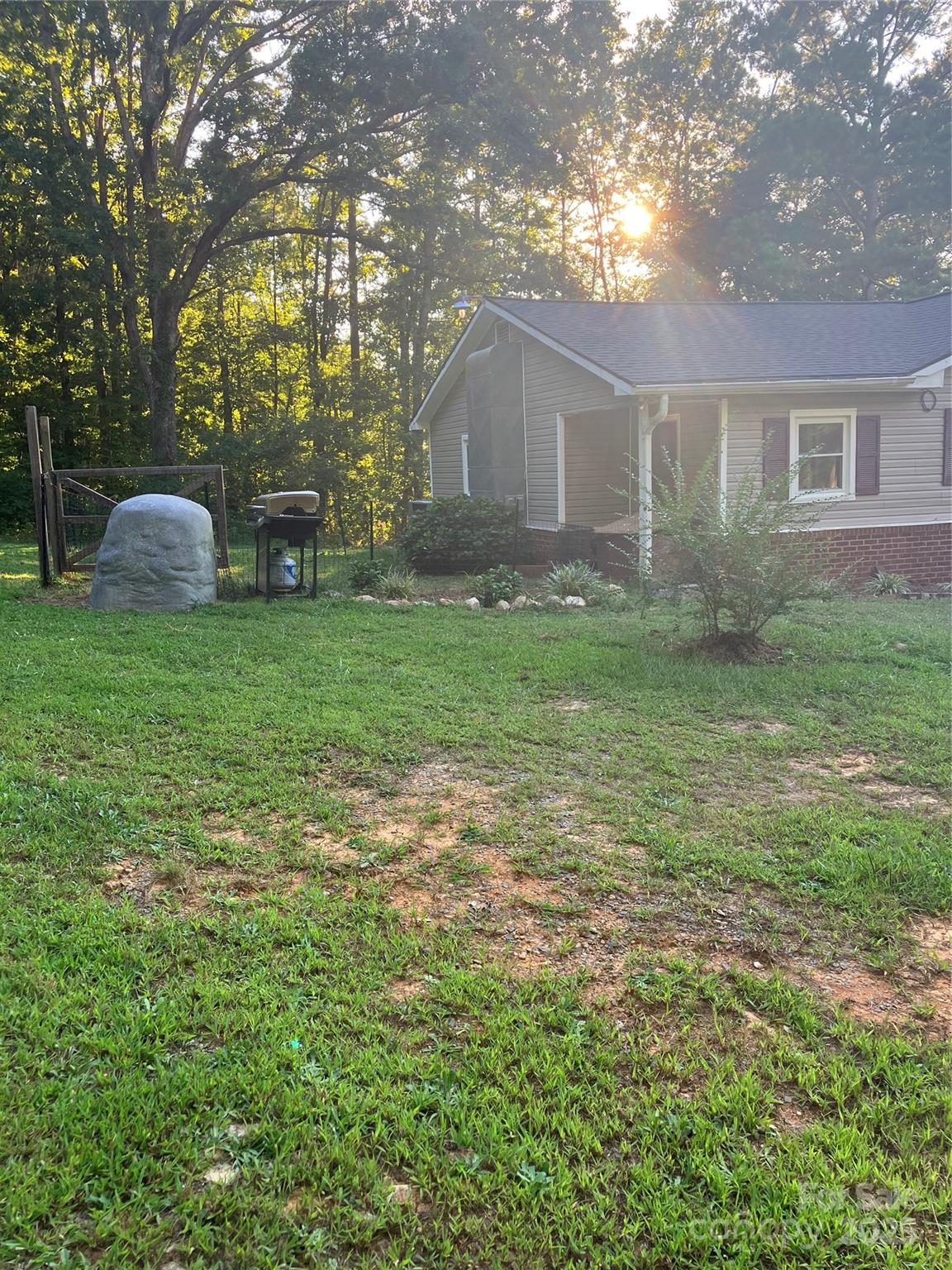 36704 Mauldin Road Albemarle, NC 28001 - Photo 6 of 33 a backyard of a house with lots of green space