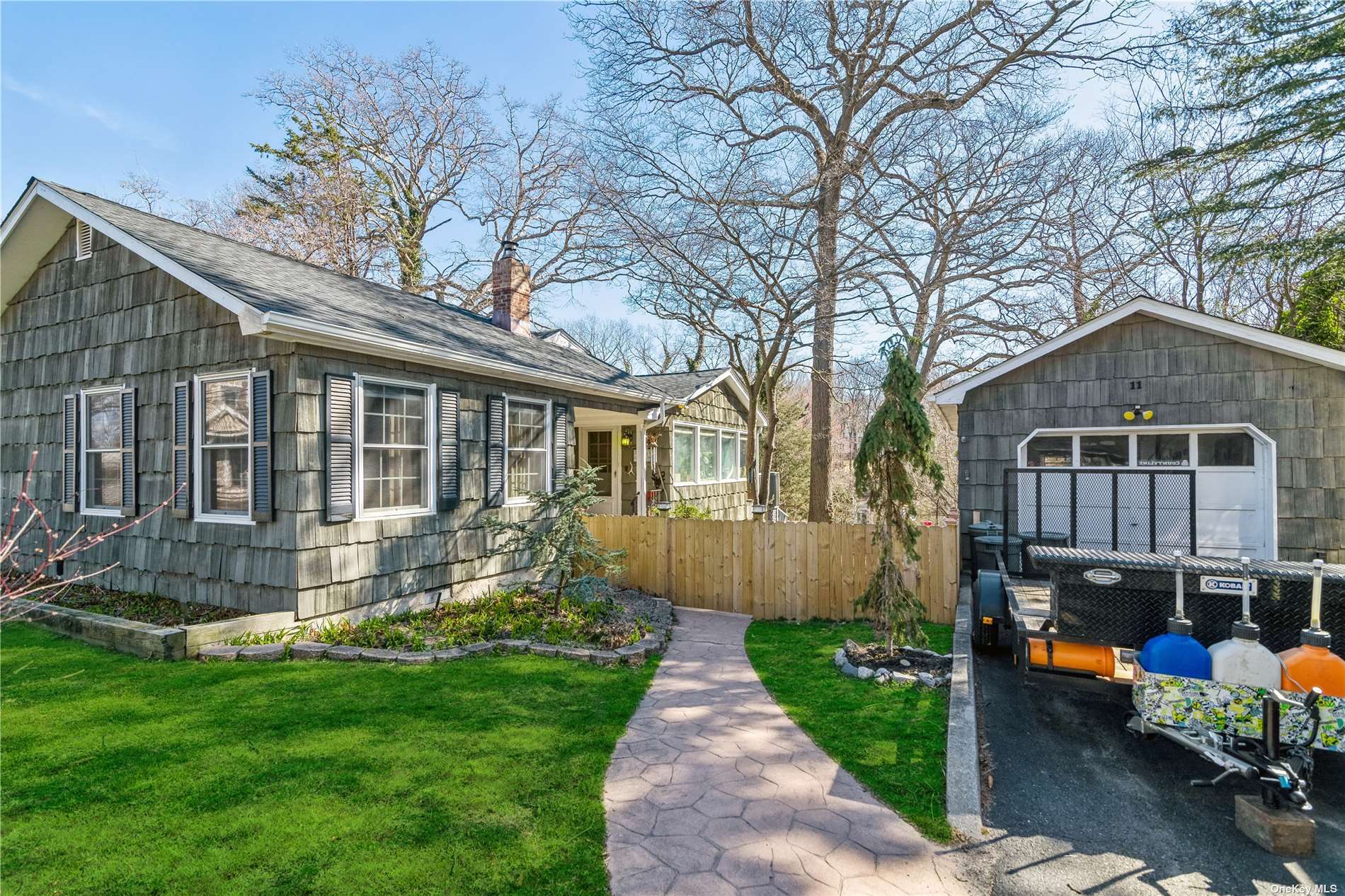 a front view of a house with a yard and potted plants