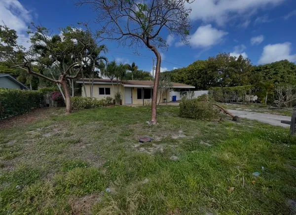 a view of house with outdoor space and garden