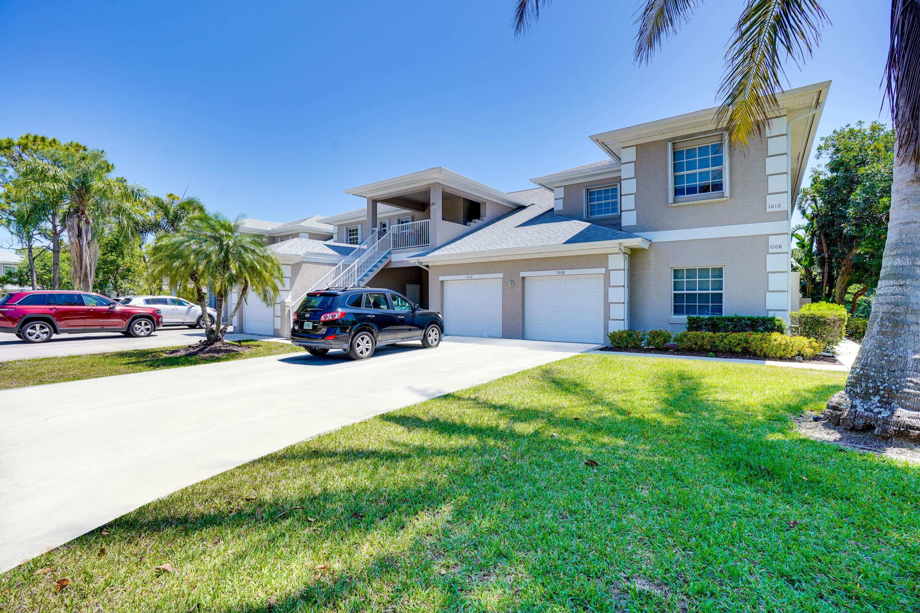 1006 Century Drive, Unit 1006 Fort Pierce, FL 34982 - Photo 1 of 35 a car parked in front of a house with a big yard