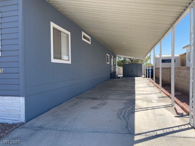 5175 Ridge Drive, Unit 149 Las Vegas, NV 89103 - Photo 6 of 33 View of patio featuring a storage shed and a carport
