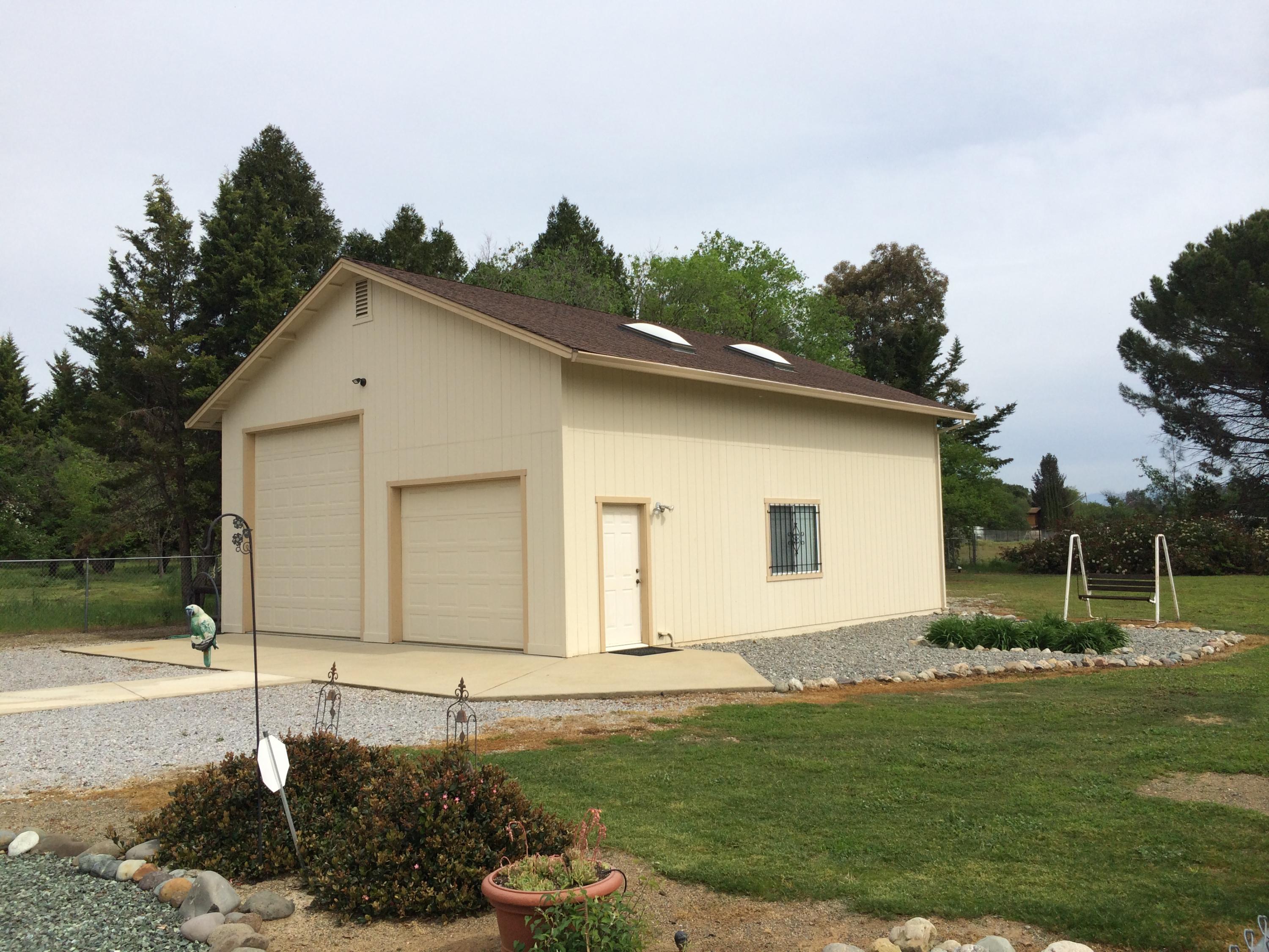 6577 Flicker Way Anderson, CA 96007 - Photo 2 of 41 a front view of a house with a garden