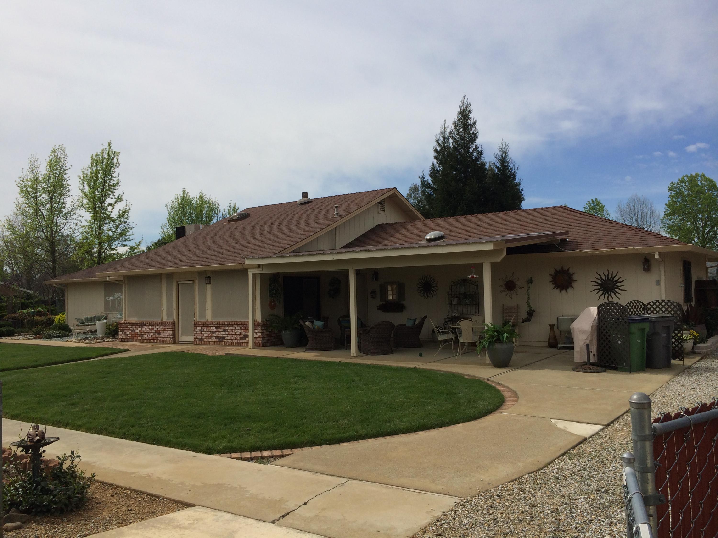 6577 Flicker Way Anderson, CA 96007 - Photo 23 of 41 a front view of a house with a yard and potted plants