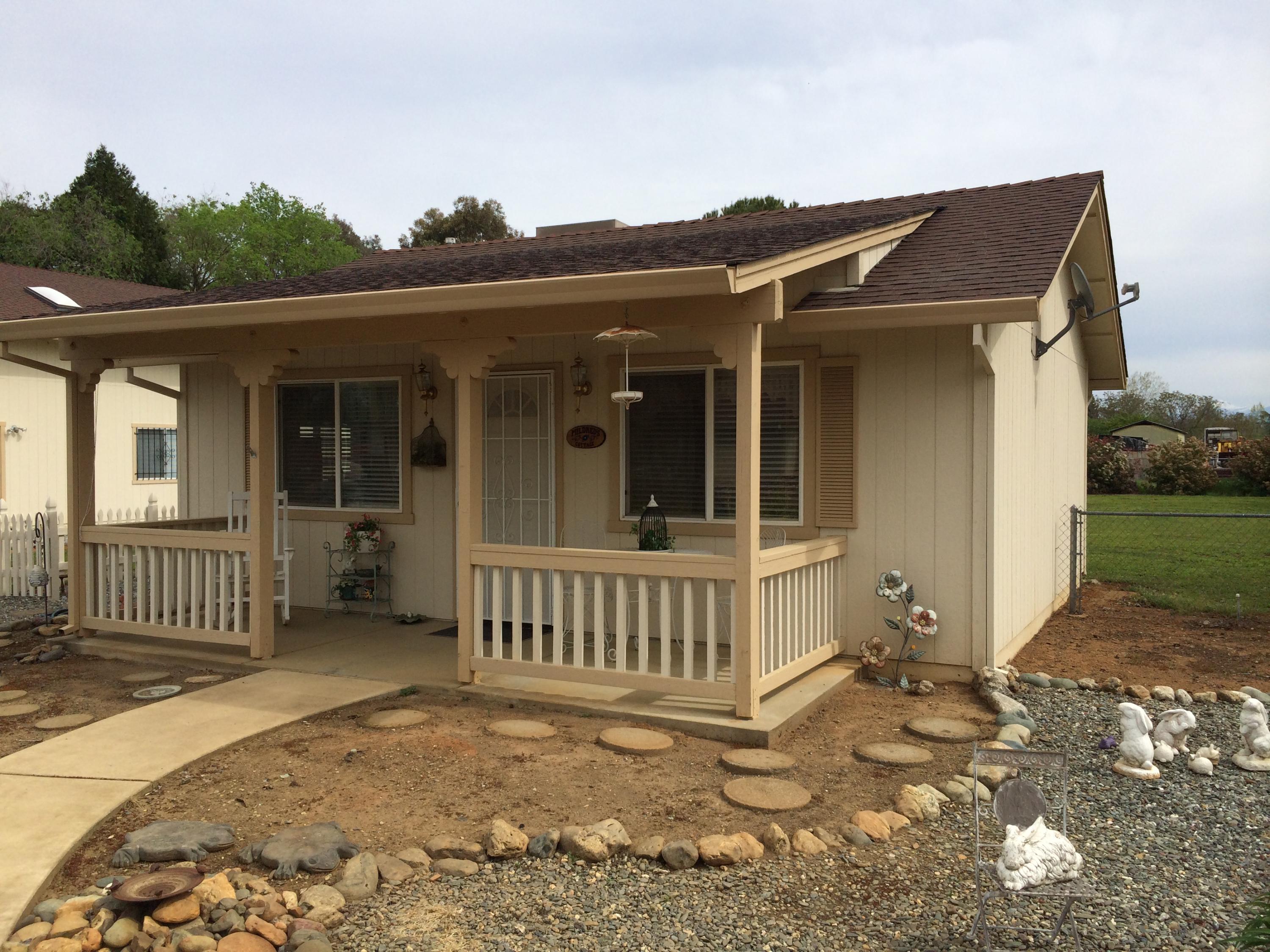 6577 Flicker Way Anderson, CA 96007 - Photo 5 of 41 a view of a house with a small yard and wooden fence