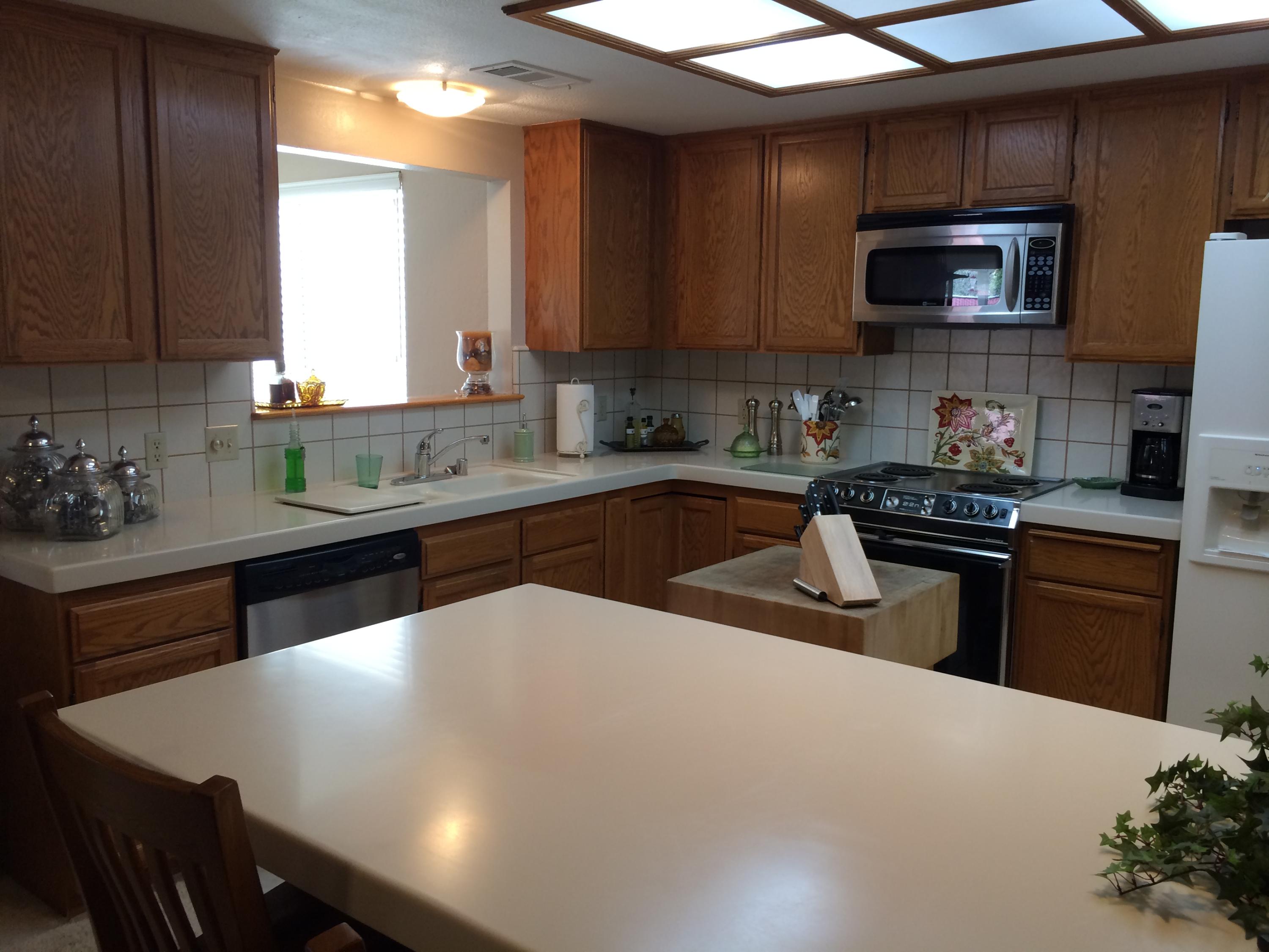 6577 Flicker Way Anderson, CA 96007 - Photo 6 of 41 a kitchen with stainless steel appliances a sink a stove a microwave cabinets and a refrigerator
