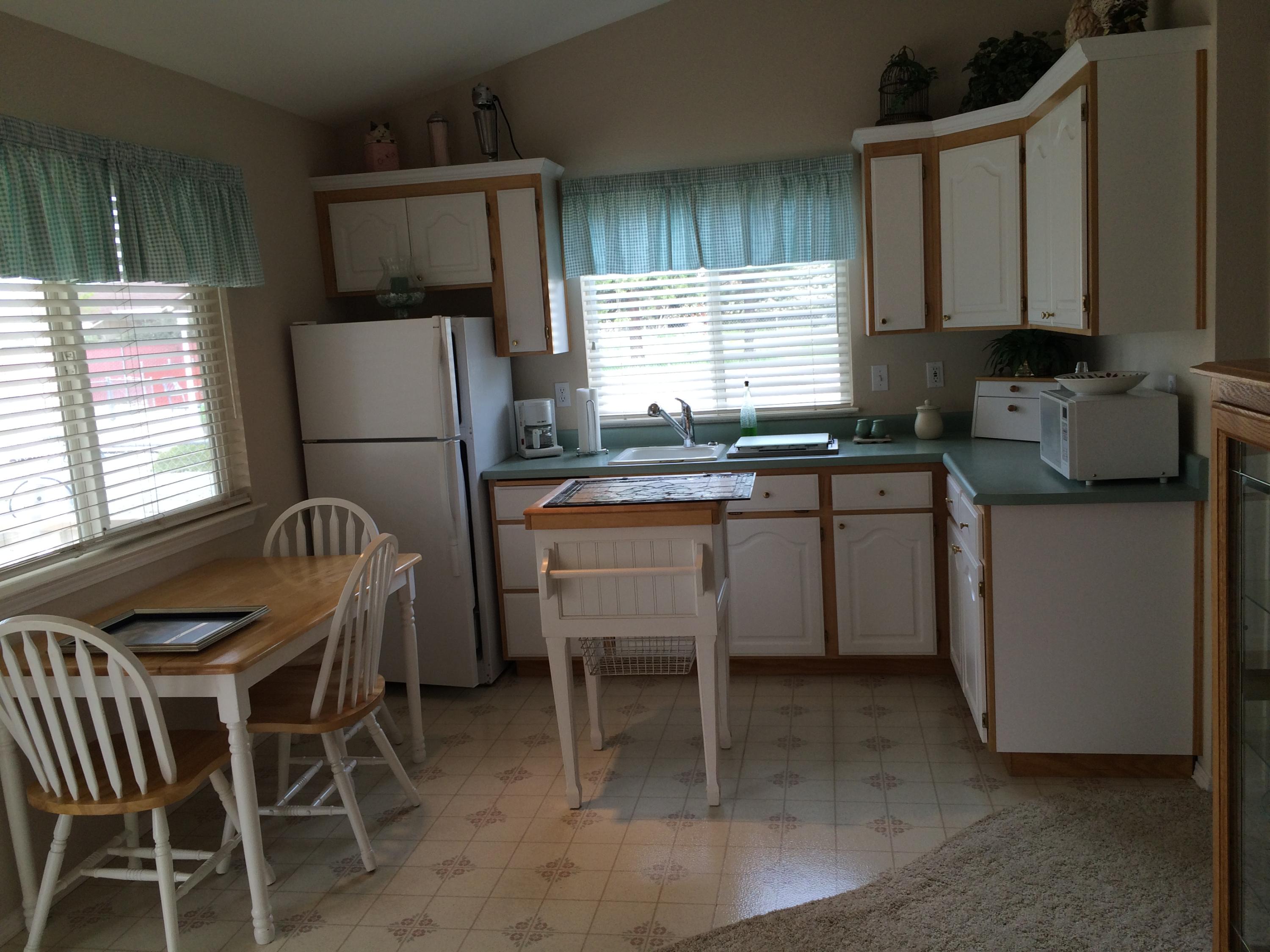 6577 Flicker Way Anderson, CA 96007 - Photo 10 of 41 a kitchen with stainless steel appliances granite countertop sink stove top oven table and chairs
