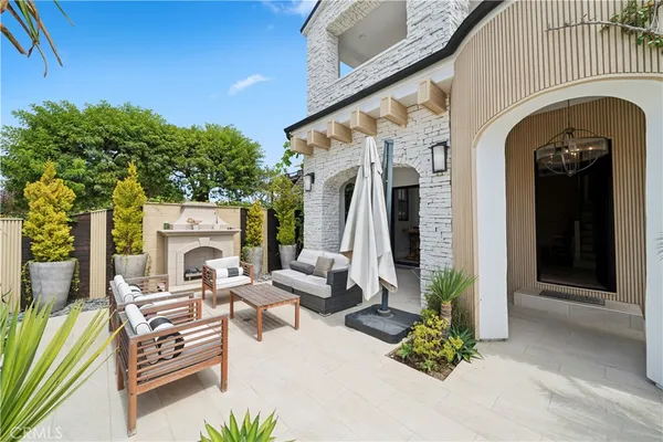 a view of a patio with table and chairs and potted plants