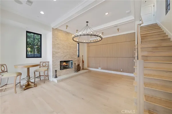 a view of an empty room with a fireplace and a window
