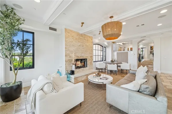 a living room with furniture a window and a potted plant
