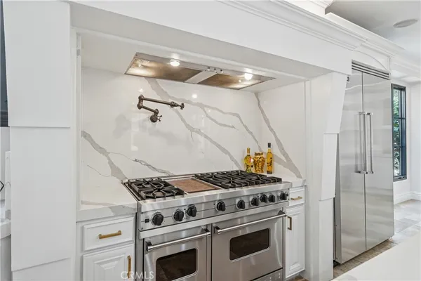 a kitchen with a stove and a refrigerator