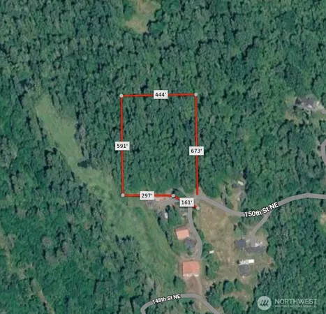 a green field with trees in the background