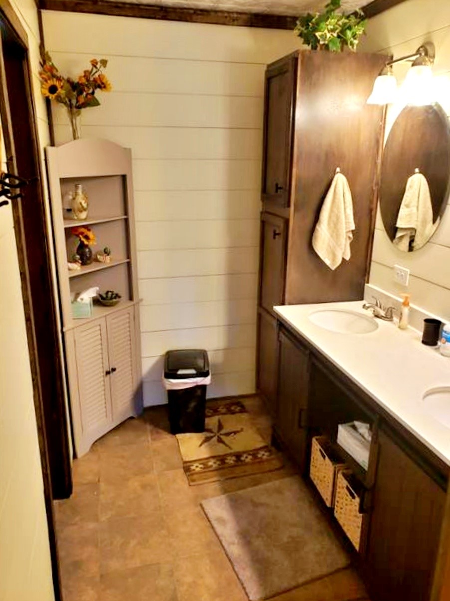 1085 Reeves Road Garwood, TX 77442 - Photo 8 of 28 a bathroom with a sink vanity and a mirror