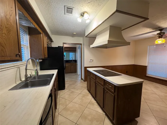 a kitchen with stainless steel appliances granite countertop a sink and a stove