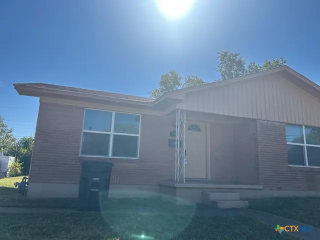 a view of backyard with a fridge