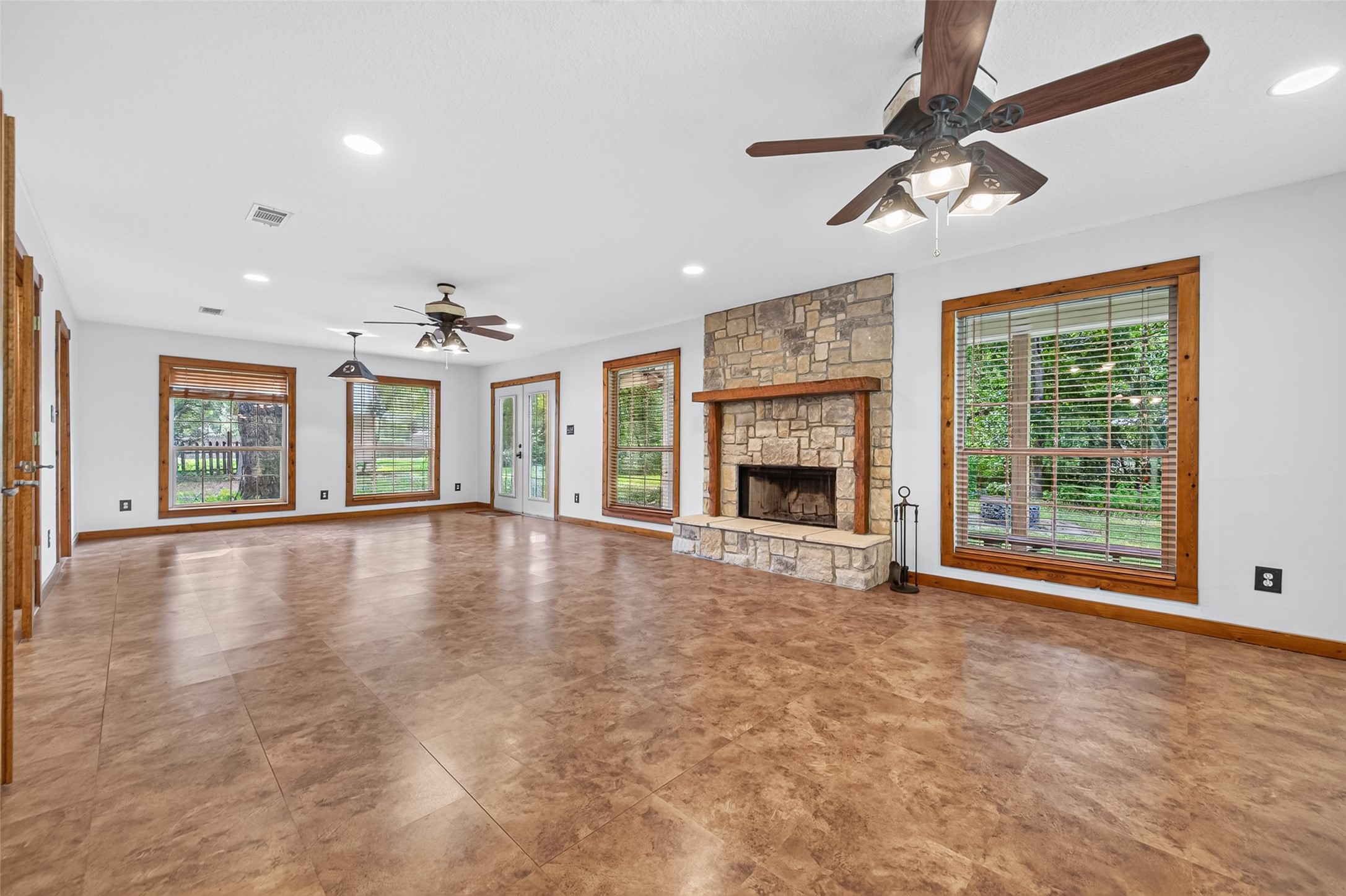 13996 Kidd Road Conroe, TX 77302 - Photo 7 of 46 Living room to breakfast area woodburning fireplace and French doors leading to other rooms