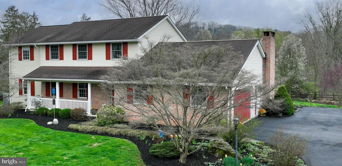 412 Wetherburn Drive Lancaster, PA 17601 - Photo 1 of 37 a front view of a house with a yard and trees