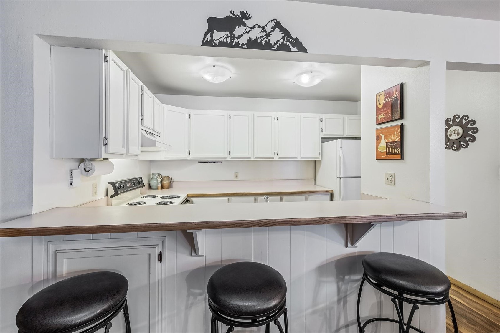 100 Wild Irishman Road, Unit 1103 Keystone, CO 80435 - Photo 7 of 33 Kitchen with a kitchen breakfast bar, white cabinets, white appliances, and kitchen peninsula
