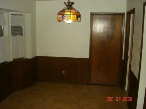 an empty room with closet and wooden floor