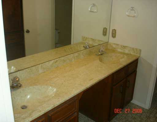 4914 Goldeneye Drive Corpus Christi, TX 78413 - Photo 8 of 10 a bathroom with a sink and a mirror