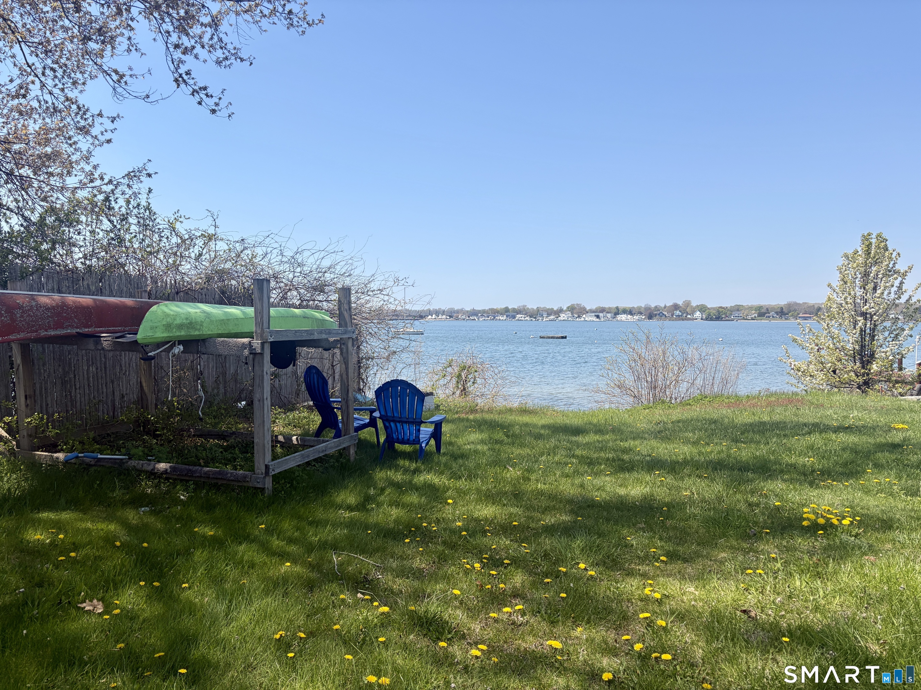8 East Wharf Road Waterford, CT 06385 - Photo 35 of 40 a view of a backyard with lawn chairs potted plants and large tree