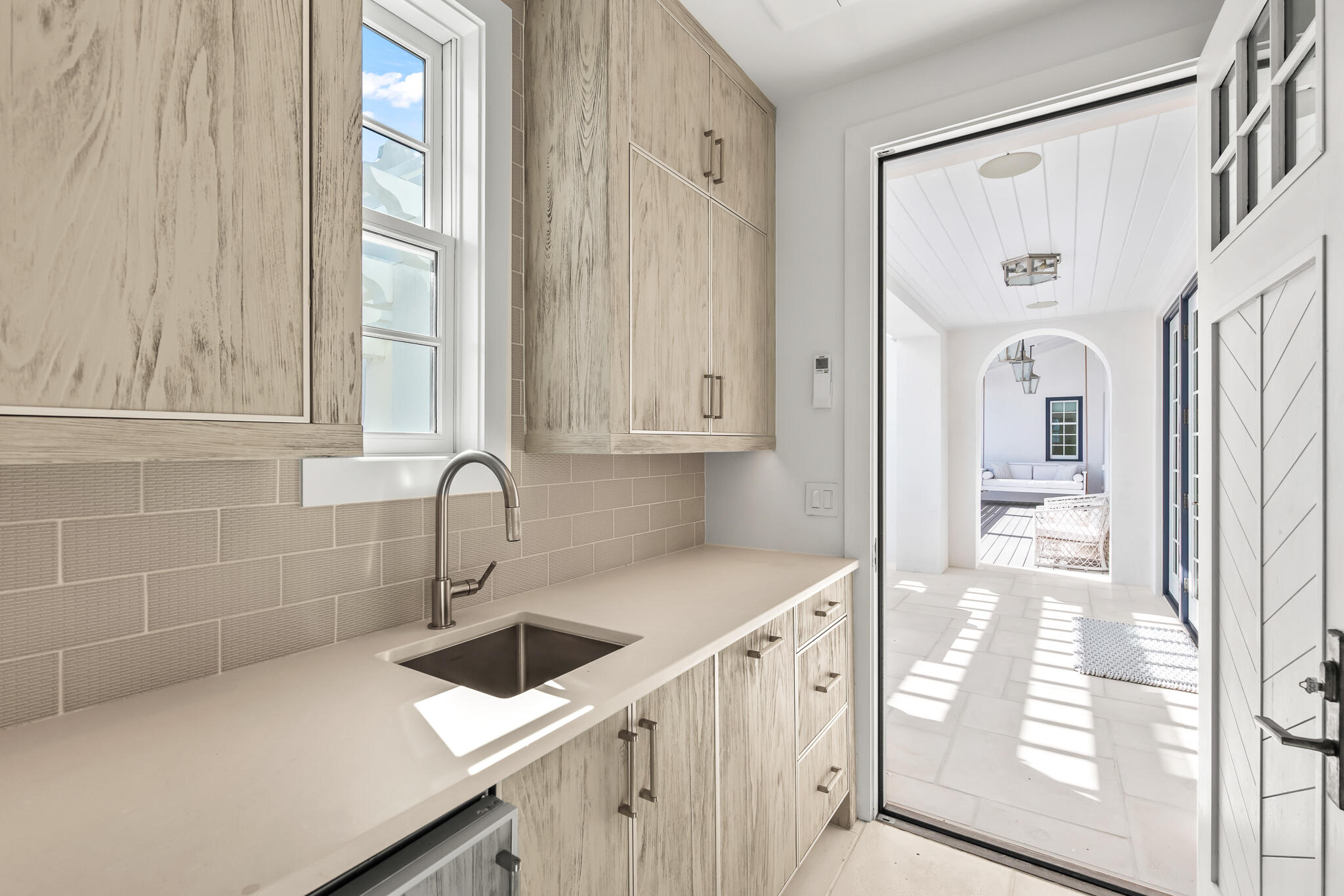 40 Smugglers Alley Inlet Beach, FL 32461 - Photo 38 of 59 a kitchen with stainless steel appliances a sink a stove and white cabinets with wooden floor