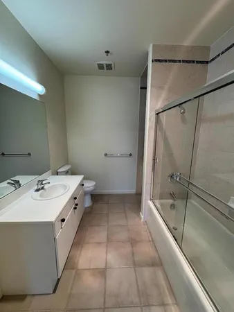 a bathroom with a tub sink and mirror