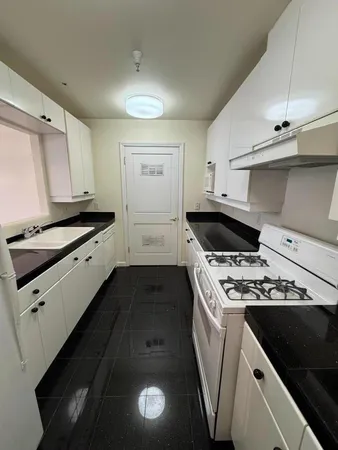 a kitchen that has a sink and a stove