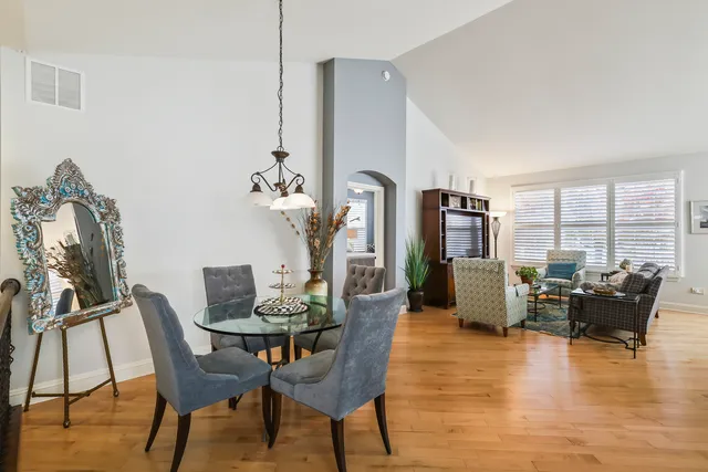 a dining room with furniture water view and wooden floor