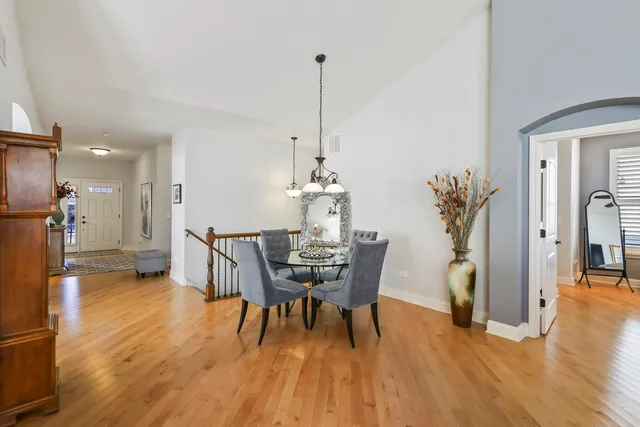 a dining room with furniture and wooden floor