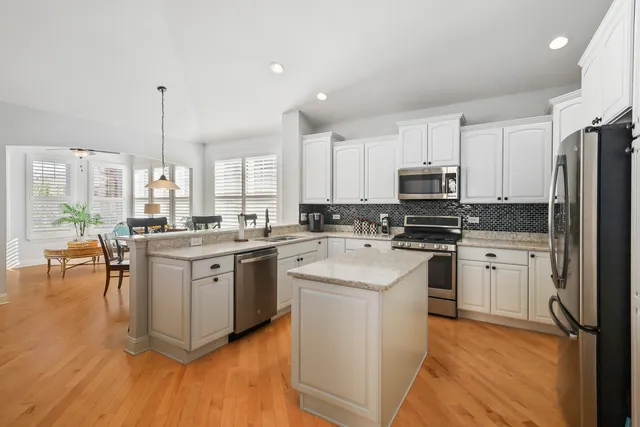 a kitchen with white cabinets and white appliances