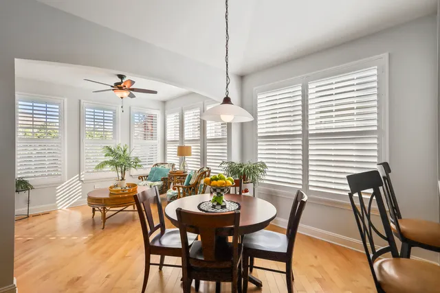 a dining room with furniture and wooden floor