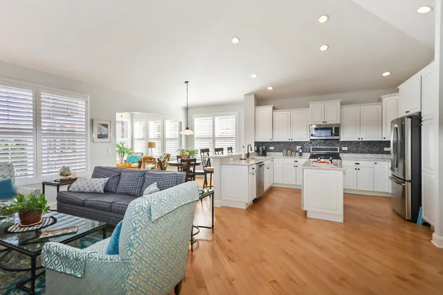 a living room with kitchen island furniture and a kitchen