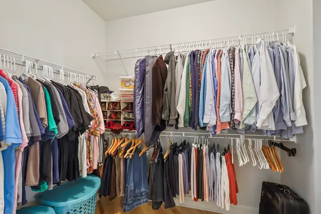 a view of walk in closet with clothes