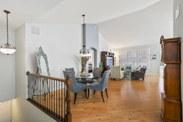 a dining room with furniture and a floor to ceiling window
