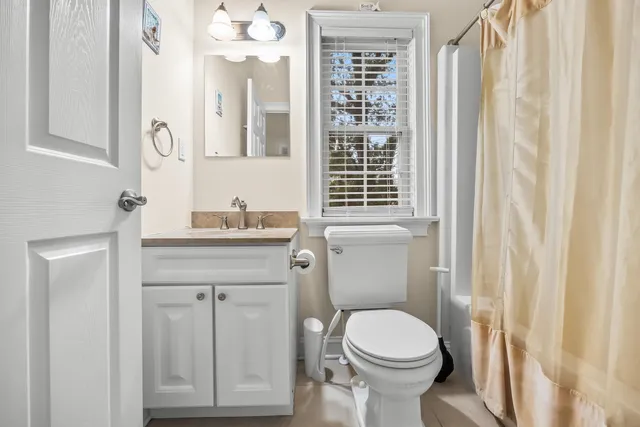 a kitchen with kitchen island granite countertop a table chairs microwave and cabinets