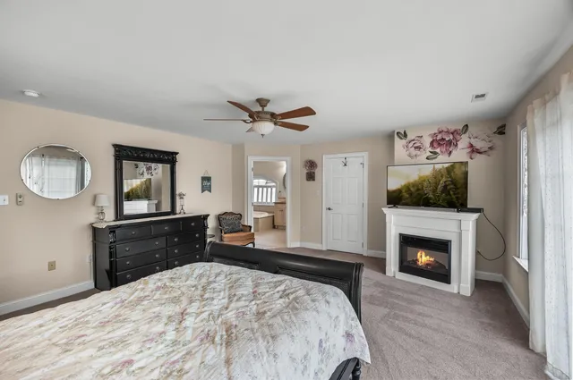 a bathroom with a granite countertop double vanity sink a mirror and a bathtub