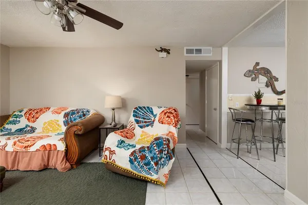 a bedroom with bed and a chandelier