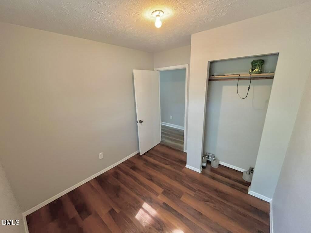 185 Summerhill Road Turkey, NC 28393 - Photo 16 of 18 an empty room with wooden floor and entrance
