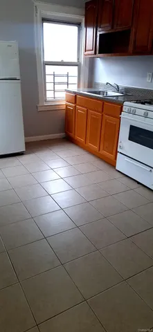 a kitchen with a sink a stove and cabinets
