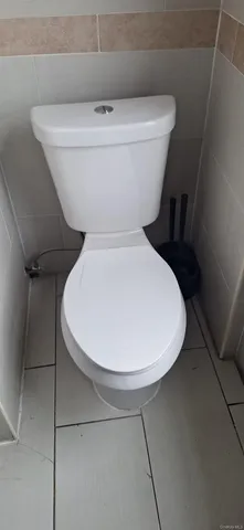 a white toilet sitting next to a white sink