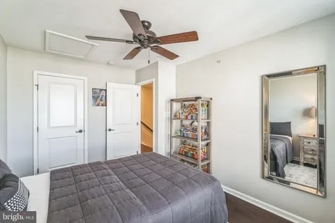 a bedroom with a bed and a mirror