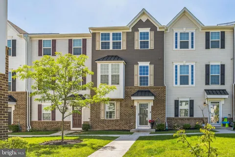 a front view of a house with swimming pool and glass windows