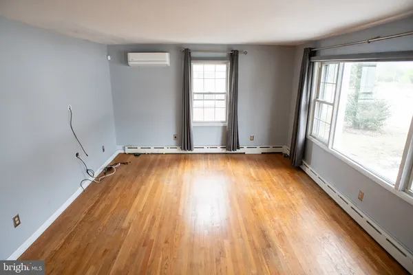 a view of a room with wooden floor and a window