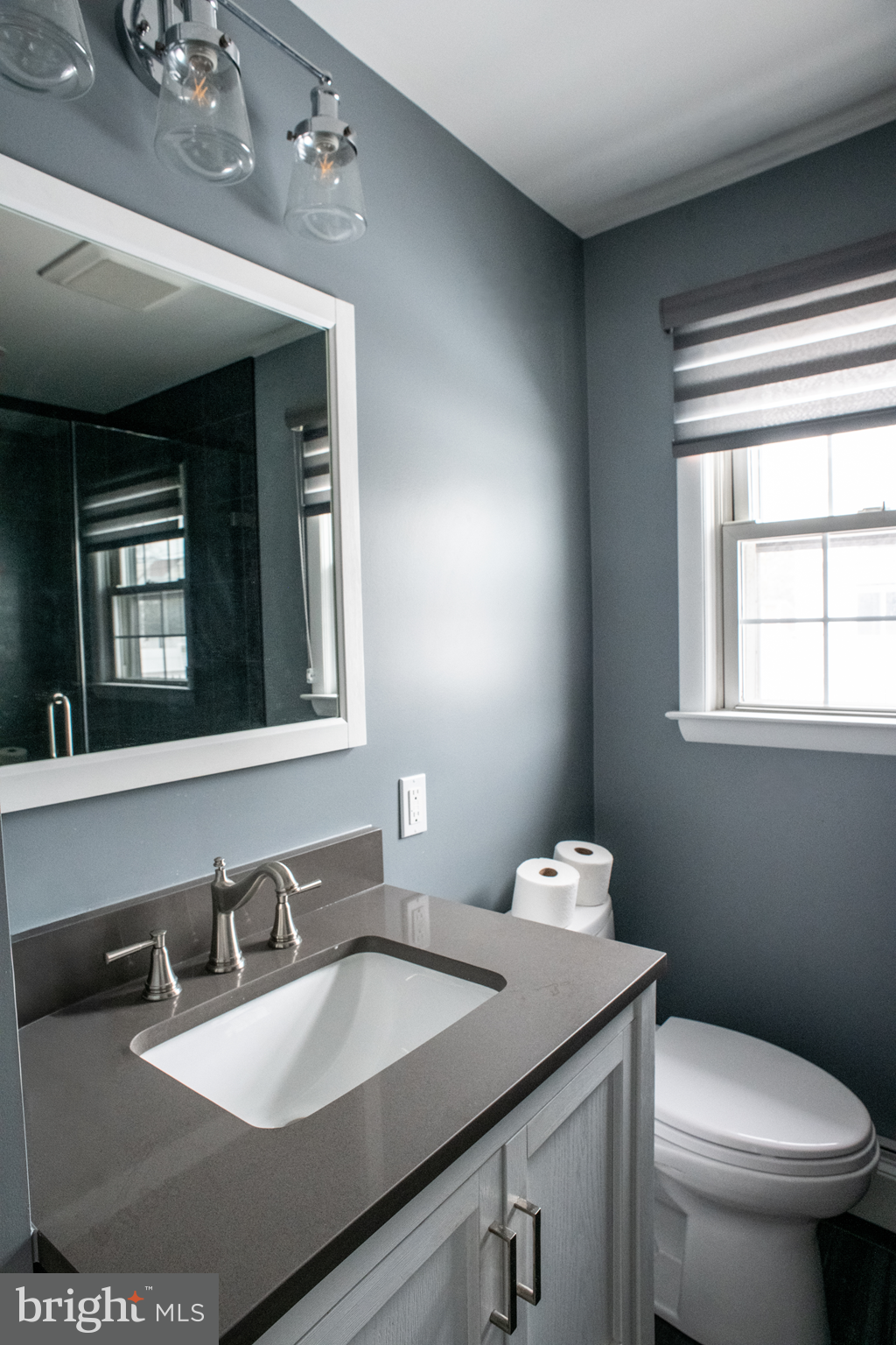 115 Murphy Road Wilmington, DE 19803 - Photo 6 of 17 a bathroom with a granite countertop sink a large mirror and a toilet
