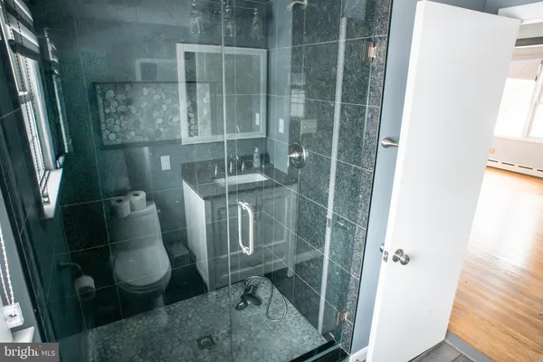 a bathroom with a sink toilet and shower